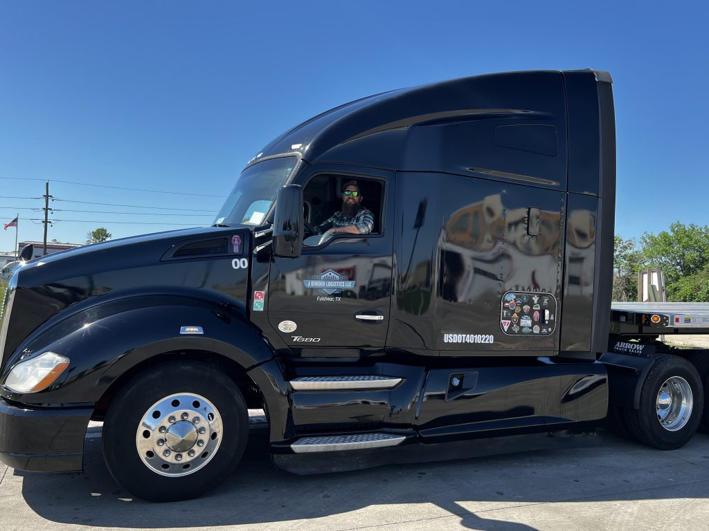 Black semi truck parked outdoors